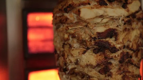 A cook cuts meat to make shawarma, gyros, doner kebab Stock Footage 128086693