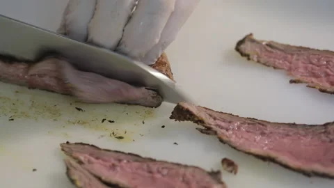 The cook cuts the meat into thin slices Stock Footage 154204942