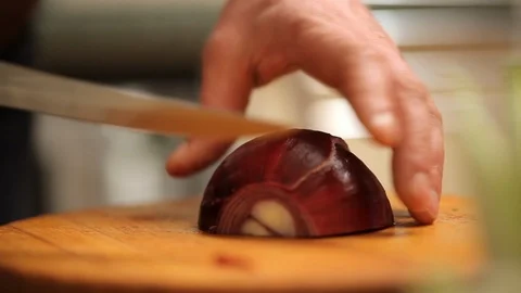 Cook cuts the onion on the desk Stock Footage 99806401