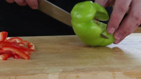 The cook cuts the pepper. slicing vegetables on a Board Stock Footage 134197194