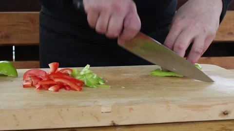 The cook cuts the pepper. slicing vegetables on a Board Stock Footage 134197239