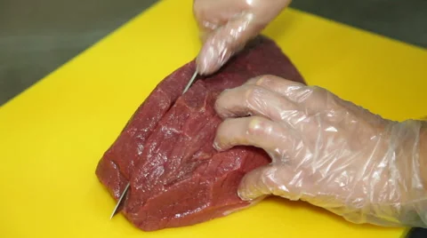 Cook Cuts a piece of Meat Stock-Footage 65726007