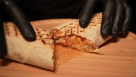 The cook cuts the pita bread in half to serve it to the table Stock Footage 239850845