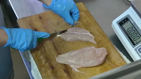 Cook cuts the raw chicken breast Stock Footage