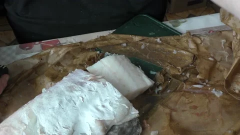 The cook cuts raw cod fish into pieces Stock Footage 180582329