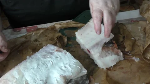 The cook cuts raw cod fish into pieces Stock Footage 180590852