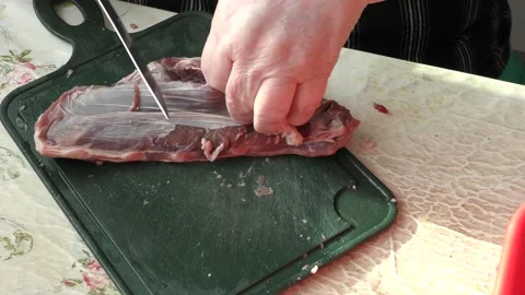The cook cuts raw deer meat with a knife. healthy food concept Stock Footage 151020214