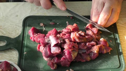 The cook cuts raw deer meat with a knife. healthy food concept 스톡 동영상 151020615