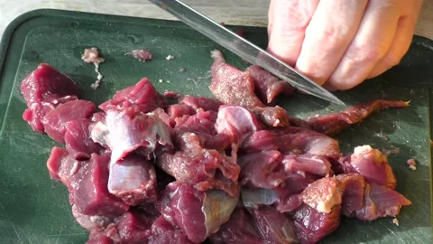 The cook cuts raw deer meat with a knife. healthy food concept Stock-Footage 151020973