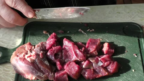 The cook cuts raw deer meat with a knife. healthy food concept Stock Footage 151021463