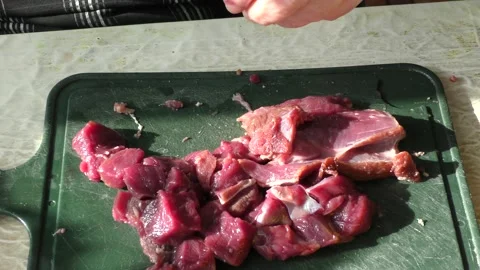 The cook cuts raw deer meat with a knife. healthy food concept Stock Footage 151021590