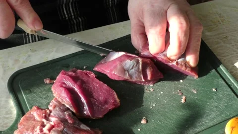 The cook cuts raw deer meat with a knife. healthy food concept Stock-Footage 151021926