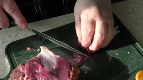 The cook cuts raw deer meat with a knife. healthy food concept Stock-Footage 151022309