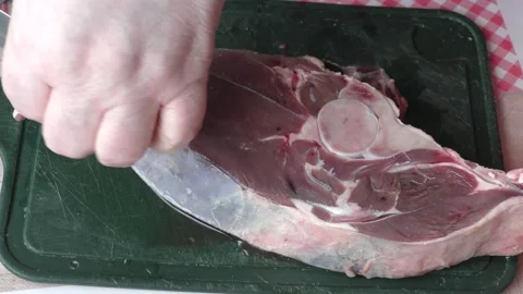 The cook cuts raw deer meat with a knife.  healthy food concept Stock Footage 154049192