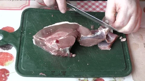 The cook cuts raw deer meat with a knife.  healthy food concept Stock Footage 154050725