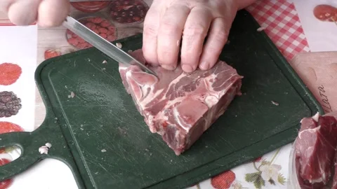 The cook cuts raw deer meat with a knife.  healthy food concept Stock Footage 154846691