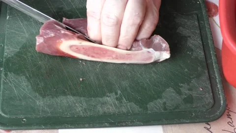 The cook cuts raw deer meat with a knife.  Healthy food concept Stock Footage 155062178
