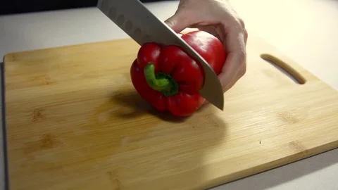 Cook cuts red bell pepper on a wooden board. Stock Footage 123363611
