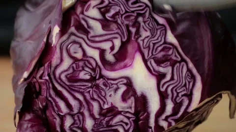 The cook cuts red cabbage with a sharp knife on a cutting board Stock Footage 127204619