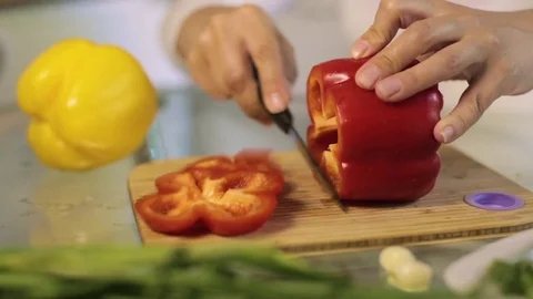 The cook cuts red pepper on a cutting board Video stock 77364964