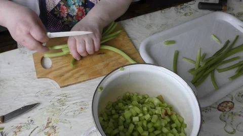 The cook cuts the rhubarb with a knife.  Healthy food concept Video stock 136635341