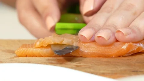 The cook cuts a salmon steak with a knife Stock Footage 88434170