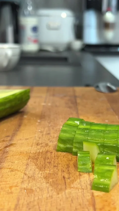 The cook cuts a spring salad of tomatoes, cucumbers, greens and mixes. Woman Stock Footage 274482696