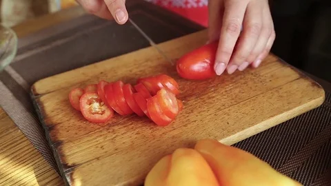 The cook cuts a tomato Stock Footage 77648967