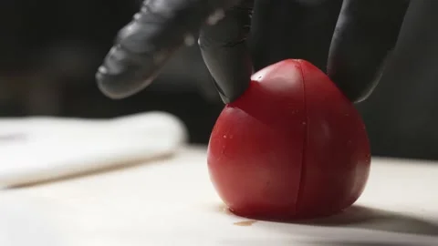A cook cuts a tomato Stock Footage 170396328