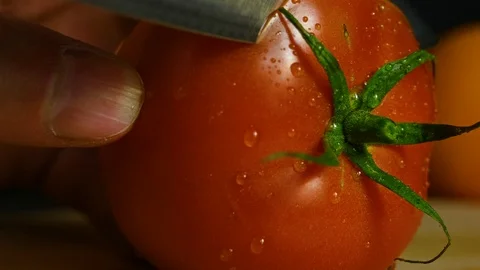 Cook cuts tomato with a knife Stock Footage 119385707