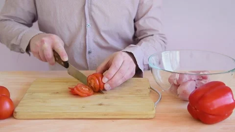 The cook cuts the tomato into slices Stock Footage 152074438