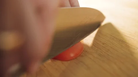 Cook cuts tomatoes with a knife Stock Footage 129956543