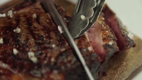 The cook cuts an uncooked piece of beef. Close-up Stock Footage 157810862