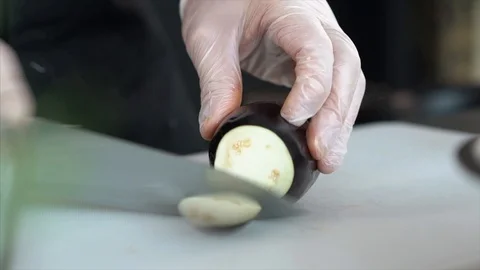Cook cuts vegetables. The cook cuts the eggplant. Veаgan food. Stock Footage 126445213