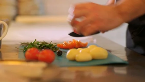 Cook cutting and chopping tomato by knife on the kitchen board Video stock 124854243