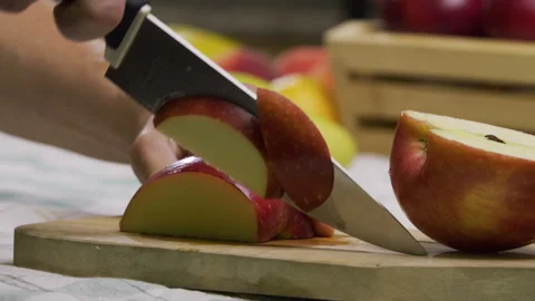 Cook cutting up apple with sharp knife on board - closeup shot Stock Footage 341273266
