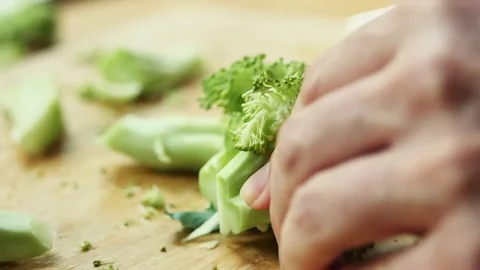 Cook cutting a broccoli floret Stock Footage 72223281