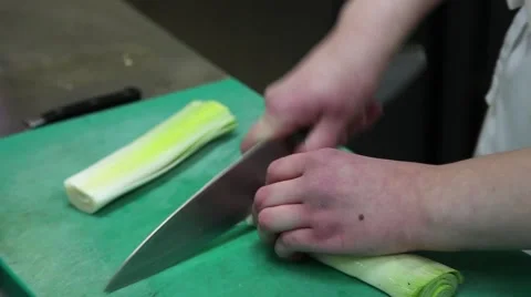 Cook cutting leek in kitchen Stock Footage 60809015