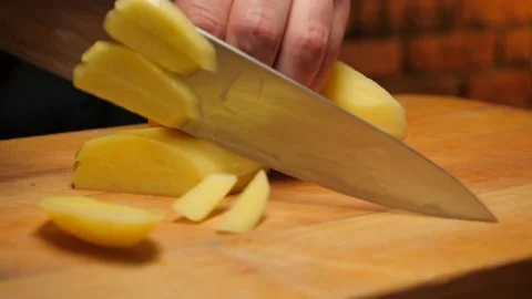 The cook cutting potato Stock Footage 143391790