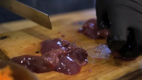 The cook is cutting a rabbit liver. Close-up. Stock Footage 159370086