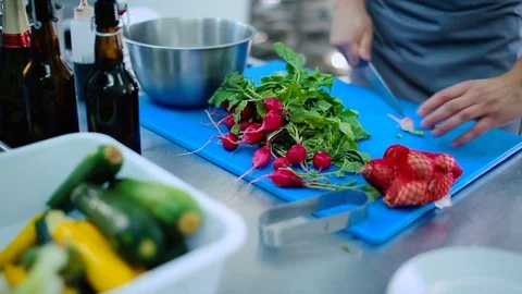 The cook cutting a radish on the board Stock Footage 77666584