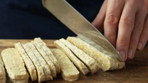 Cook cutting tempeh Stock Footage 71677351