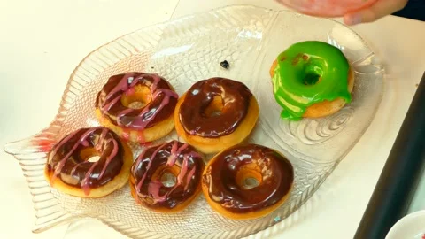The cook decorates chocolate donuts Stock Footage 86114587