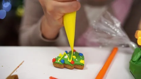 Cook decorates the gingerbread pattern with a pastry bag 스톡 동영상 255626515