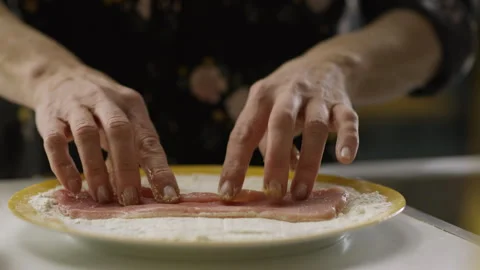 The cook dips the filet in flour. Slow motion Stock Footage 263971403
