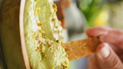 The cook dips a slice of bread into whipped feta . Vertical video. Vidéo 333708410