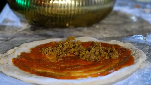 Cook does preparation for pizza. Imposes mincemeat on paste. Stock Footage 100038944