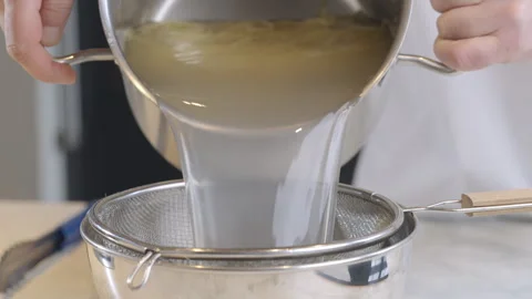 Cook draining spaghetti in colander slow motion video. Video stock 274070392