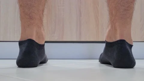 Cook dropped eggshells on the floor while cooking, Close-up of the legs of a man Stock Footage 202143316