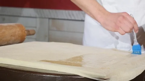 Cook Egg Brush Lubricates the Thin Sheet of Dough For the Pie, Rectangular Stock Footage 77564739